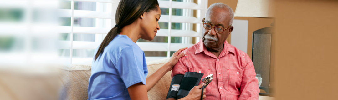 young woman checking the blood pressure of an old man