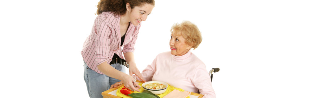 young woman serving foods to an old woman
